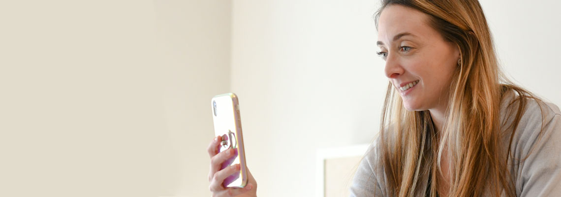 woman using a cellphone for a telemedicine appointment